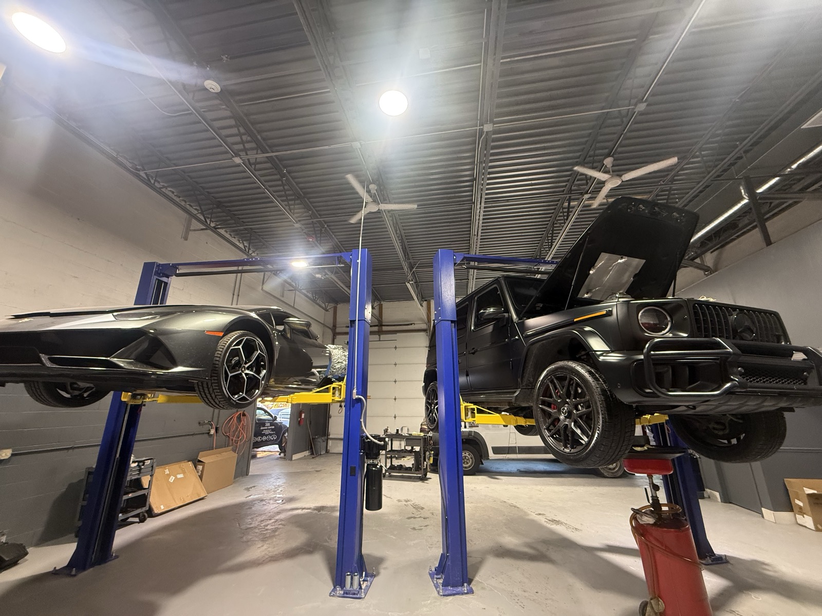 Exotic cars on lifts at INF Performance Chicago